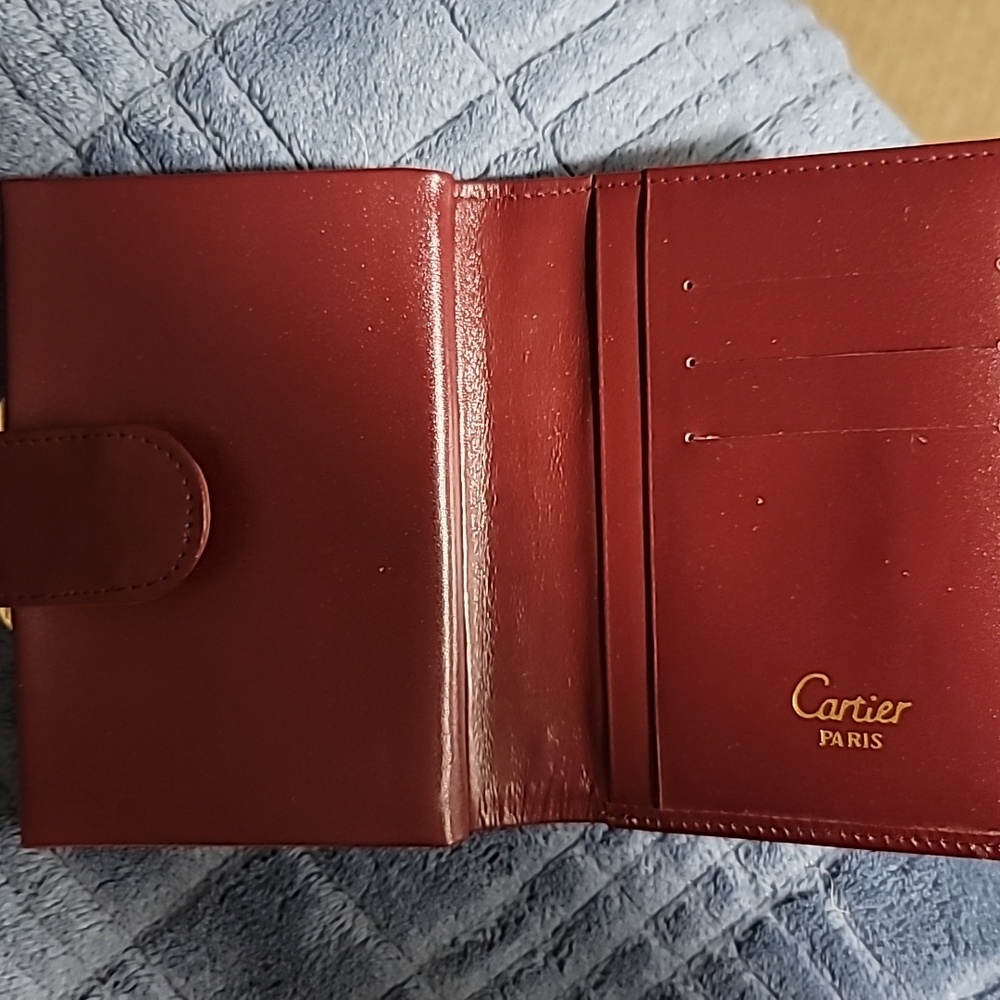 Never used Cartier wallet w/ change . Never been used, has a scuff on the back.